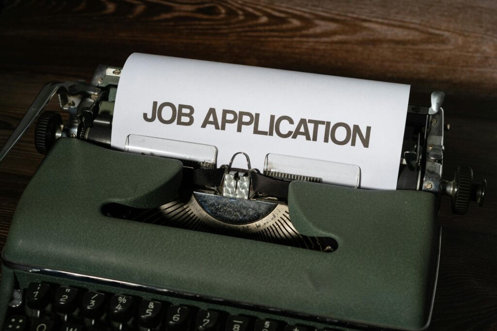 Close-up of a vintage typewriter with a job application paper inserted.